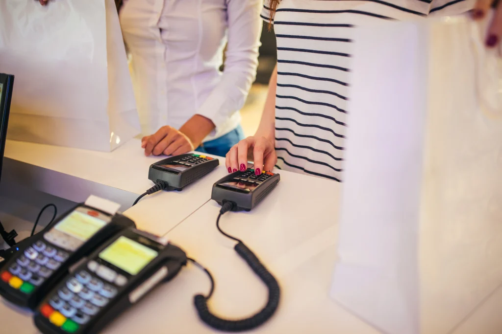 Female making payment using POS machine