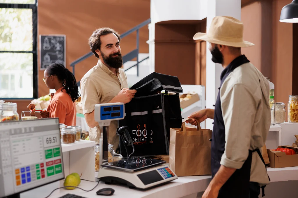 Retail staff using POS terminal in store