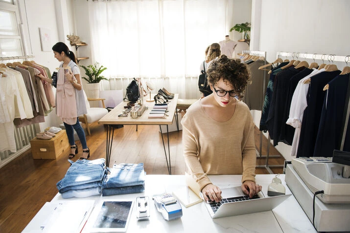 Boutique owner using laptop