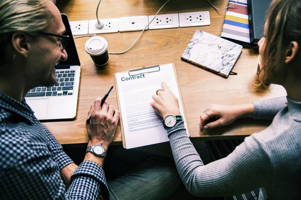 Professionals reviewing contract documents during business consultation