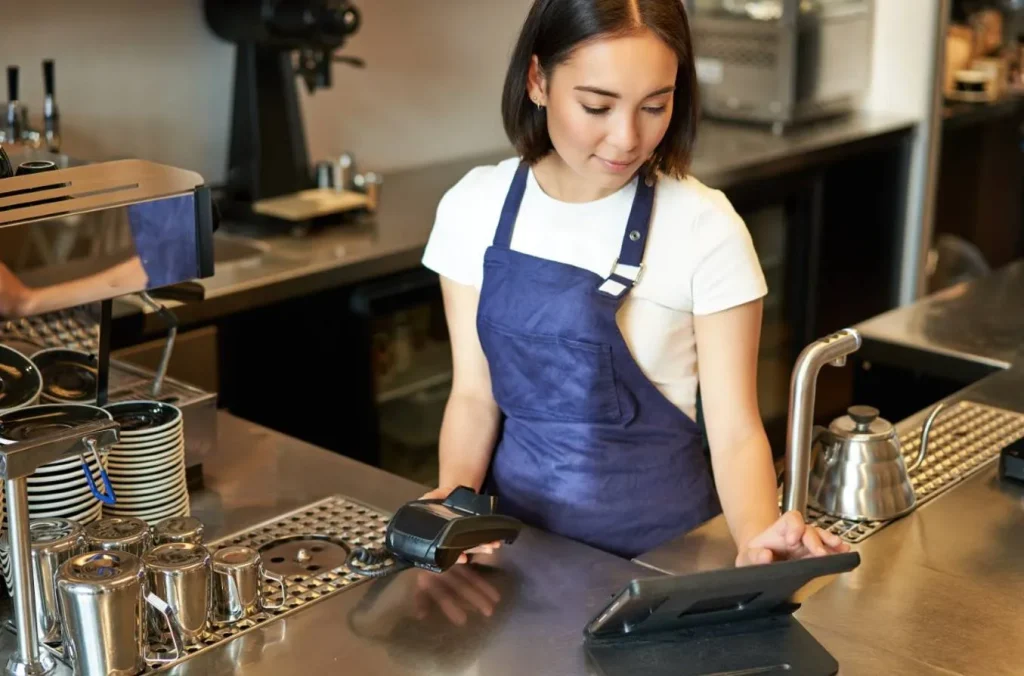Barista processing payment with POS system