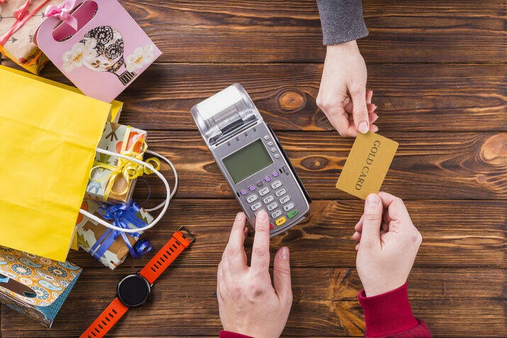 Customer paying with a credit card using a POS payment terminal