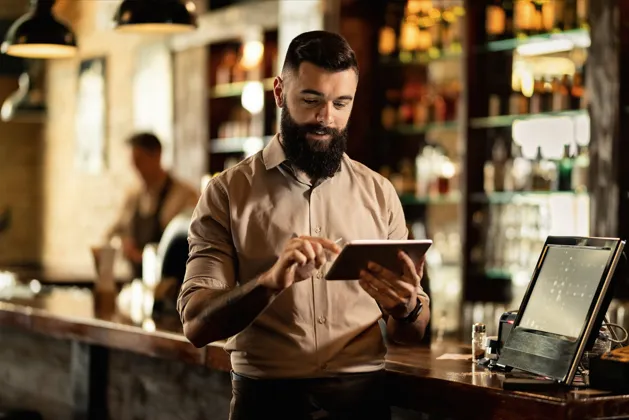 Restaurant staff managing orders with modern POS