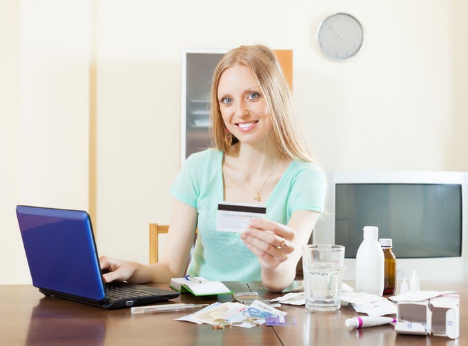 Woman making an online credit card payment using a laptop