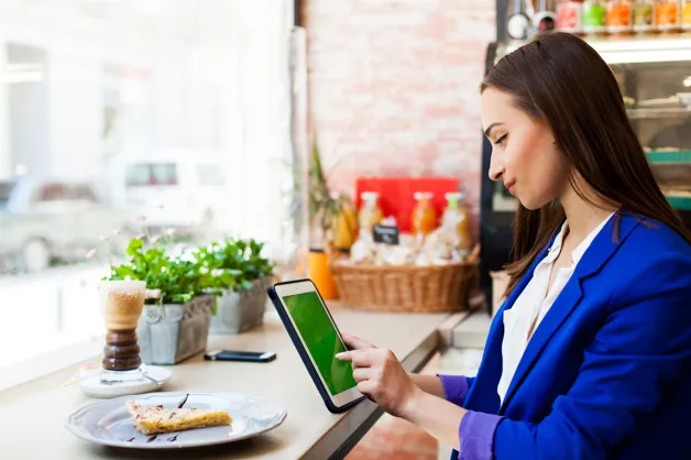Customer ordering food through tablet POS system