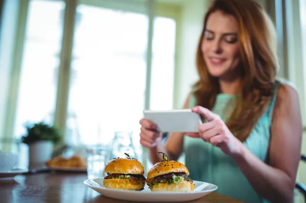 Customer photographing restaurant food