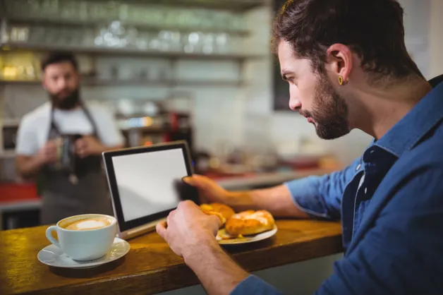 Restaurant customer using self service POS tablet
